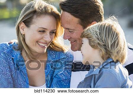Stock Image - Family smiling together outdoors. Fotosearch