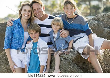 Stock Photography - Family smiling together outdoors. Fotosearch