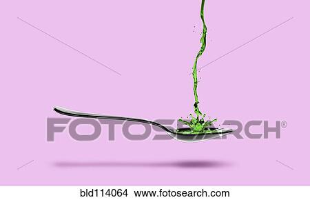 Green medicine pouring into spoon View Large Photo Image Picture - Green medicine pouring into spoon. Fotosearch