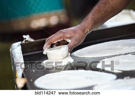 Stock Photo - Hands cooking on grill top. Fotosearch