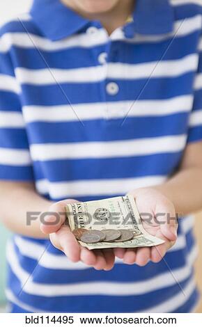 Stock Photography - Hispanic boy holding money. Fotosearch