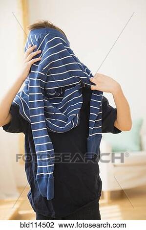Hispanic boy pulling on sweater View Large Photo Image Stock Image - Hispanic boy pulling on sweater. Fotosearch
