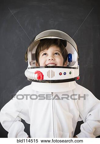 Hispanic boy wearing space helmet in classroom View Large Photo Image Stock Photography - Hispanic boy wearing space helmet in classroom. Fotosearch