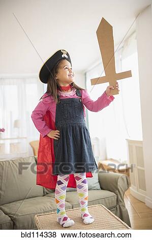 Hispanic girl playing with ape and sword View Large Photo Image Stock Photo - Hispanic girl playing with ape and sword. Fotosearch