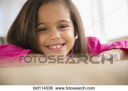 Stock Photograph - Hispanic girl smiling on counter. Fotosearch