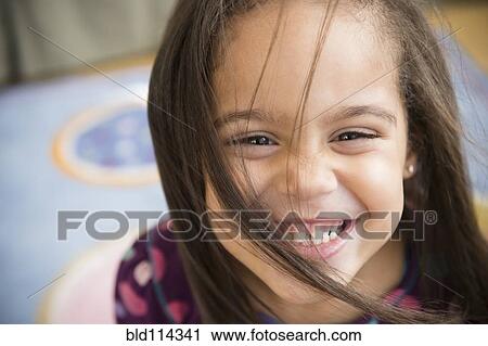 Stock Image - Hispanic girl smiling. Fotosearch