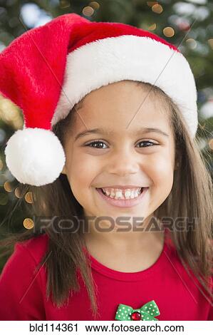 Hispanic girl wearing Santa hat View Large Photo Image Stock Image - Hispanic girl wearing Santa hat. Fotosearch