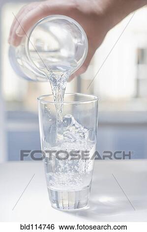 Hispanic man pouring glass of water View Large Photo Image Stock Photograph - Hispanic man pouring glass of water. Fotosearch