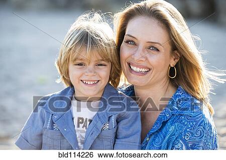 Stock Photograph - Hispanic mother and son smiling outdoors. Fotosearch