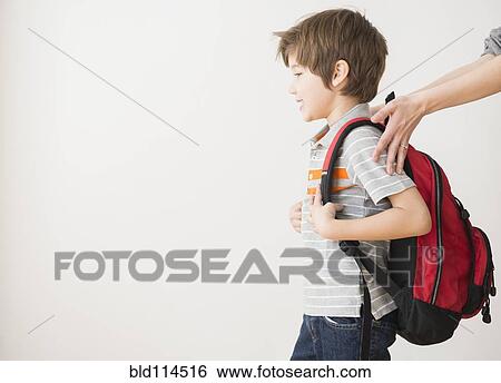 Stock Photograph - Hispanic mother rushing son to school. Fotosearch