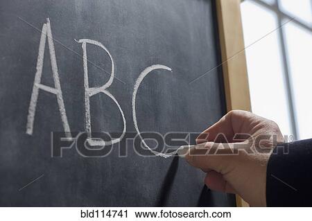 Hispanic teacher writing 'ABC' on chalkboard View Large Photo Image Stock Image - Hispanic teacher writing 'ABC' on chalkboard. Fotosearch