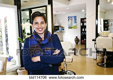 Stock Photograph - Hispanic woman smiling in salon. Fotosearch