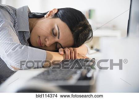 Indian businesswoman sleeping on desk in office View Large Photo Image Picture - Indian businesswoman sleeping on desk in office. Fotosearch