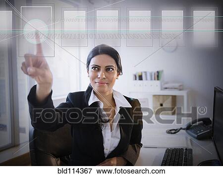 Indian businesswoman using touchscreen View Large Photo Image Stock Photo - Indian businesswoman using touchscreen. Fotosearch