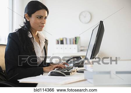 Indian businesswoman working at desk View Large Photo Image Stock Photograph - Indian businesswoman working at desk. Fotosearch