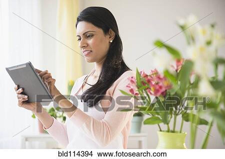 Indian florist using tablet computer View Large Photo Image Picture - Indian florist using tablet computer. Fotosearch