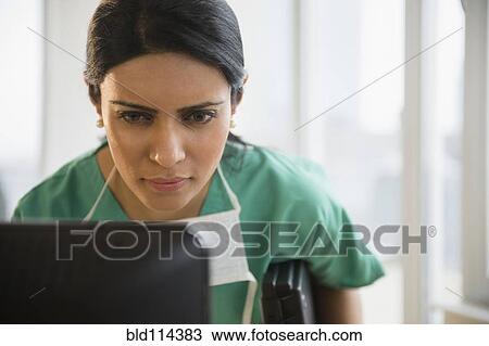 Indian nurse using laptop in office View Large Photo Image Stock Image - Indian nurse using laptop in office. Fotosearch