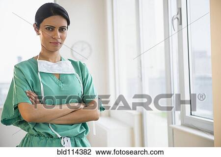 Indian nurse with arms crossed in office View Large Photo Image Stock Image - Indian nurse with arms crossed in office. Fotosearch