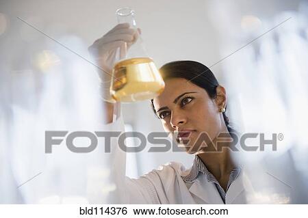 Indian scientist examining chemicals in lab View Large Photo Image Stock Photograph - Indian scientist examining chemicals in lab. Fotosearch