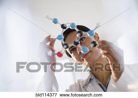 Stock Photo - Indian scientist examining molecular model in lab. Fotosearch