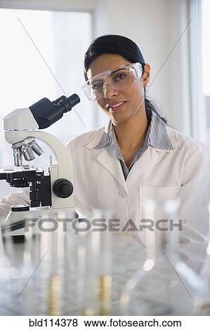 Indian scientist using microscope in lab View Large Photo Image Stock Photo - Indian scientist using microscope in lab. Fotosearch