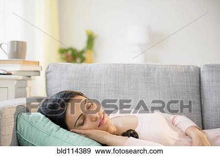 Indian woman napping on sofa View Large Photo Image Stock Photo - Indian woman napping on sofa. Fotosearch