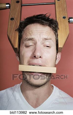 Man wearing vice on head View Large Photo Image Stock Image - Man wearing vice on head. Fotosearch