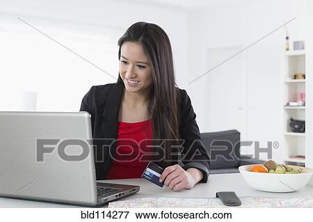 Mixed race businesswoman shopping online View Large Photo Image Stock Photo - Mixed race businesswoman shopping online. Fotosearch