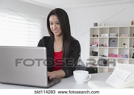 Mixed race businesswoman using laptop View Large Photo Image Stock Image - Mixed race businesswoman using laptop. Fotosearch