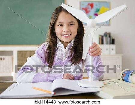 Mixed race girl holding model wind turbine in class View Large Photo Image Stock Image - Mixed race girl holding model wind turbine in class. Fotosearch