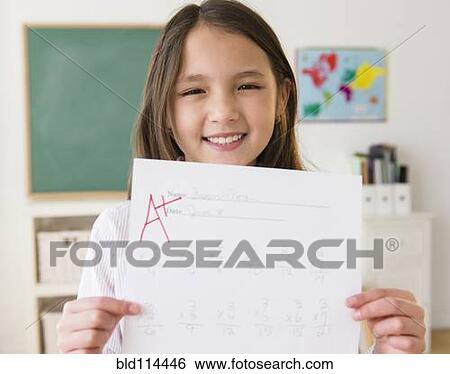 Mixed race girl holding paper with A+ grade View Large Photo Image Stock Photograph - Mixed race girl holding paper with A+ grade. Fotosearch