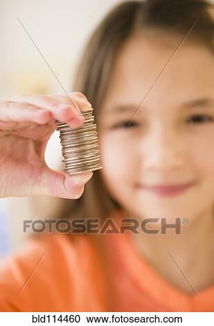 Mixed race girl holding stack of coins View Large Photo Image Stock Image - Mixed race girl holding stack of coins. Fotosearch