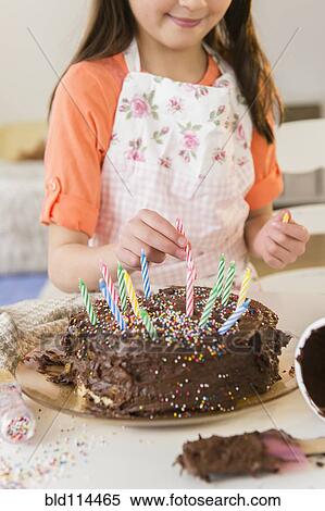Mixed race girl making birthday cake in kitchen View Large Photo Image Stock Photography - Mixed race girl making birthday cake in kitchen. Fotosearch