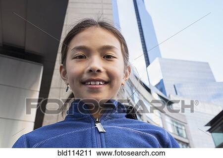 Mixed race girl smiling on city street View Large Photo Image Stock Image - Mixed race girl smiling on city street. Fotosearch