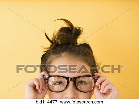 Stock Photo - Mixed race girl wearing glasses. Fotosearch