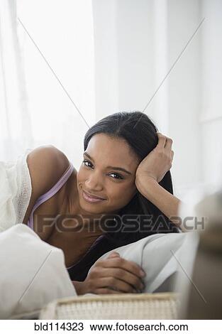 Mixed race woman laying in bed View Large Photo Image Stock Image - Mixed race woman laying in bed. Fotosearch
