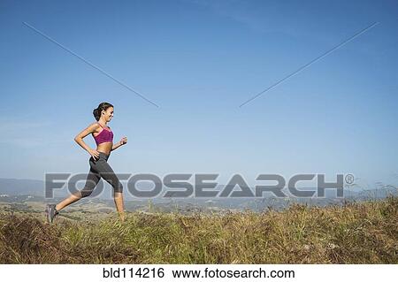 Mixed race woman running in rural landscape View Large Photo Image Stock Photograph - Mixed race woman running in rural landscape. Fotosearch