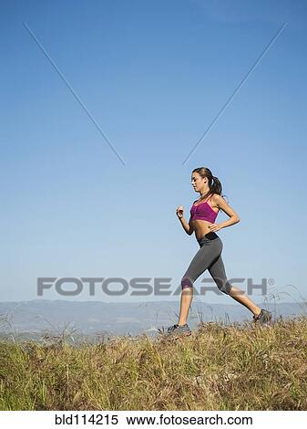 Mixed race woman running in rural landscape View Large Photo Image Stock Photography - Mixed race woman running in rural landscape. Fotosearch