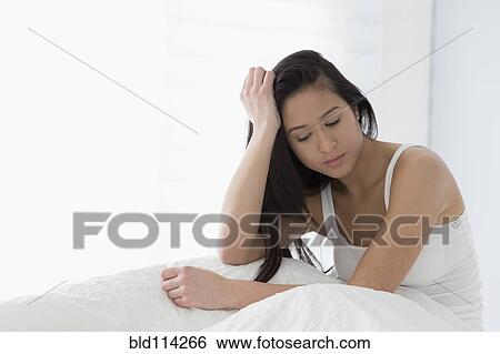 Mixed race woman sitting in bed View Large Photo Image Stock Photograph - Mixed race woman sitting in bed. Fotosearch
