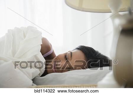 Mixed race woman sleeping in bed View Large Photo Image Stock Image - Mixed race woman sleeping in bed. Fotosearch