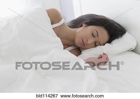 Mixed race woman sleeping in bed View Large Photo Image Stock Photo - Mixed race woman sleeping in bed. Fotosearch