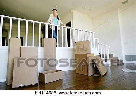 Stock Photograph - Mixed race woman smiling in new home. Fotosearch