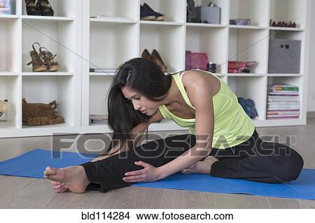 Mixed race woman stretching on yoga mat View Large Photo Image Picture - Mixed race woman stretching on yoga mat. Fotosearch