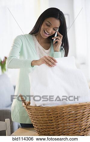 Stock Photograph - Mixed race woman talking on cell phone. Fotosearch