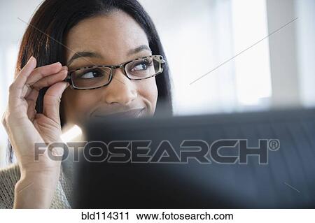 Mixed race woman wearing eyeglasses View Large Photo Image Stock Image - Mixed race woman wearing eyeglasses. Fotosearch