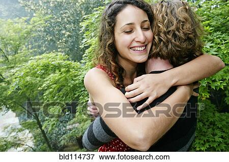 Smiling couple hugging outdoors View Large Photo Image Stock Photo - Smiling couple hugging outdoors. Fotosearch
