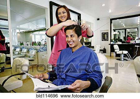 Stock Photograph - Woman having hair cut in salon. Fotosearch