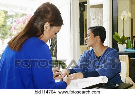 Woman having nails done in salon View Large Photo Image Picture - Woman having nails done in salon. Fotosearch