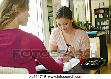 Woman having nails done in salon View Large Photo Image Stock Photo - Woman having nails done in salon. Fotosearch