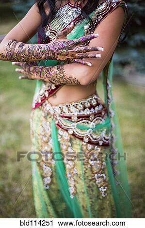 Stock Image - Woman wearing traditional Indian henna and robes. Fotosearch